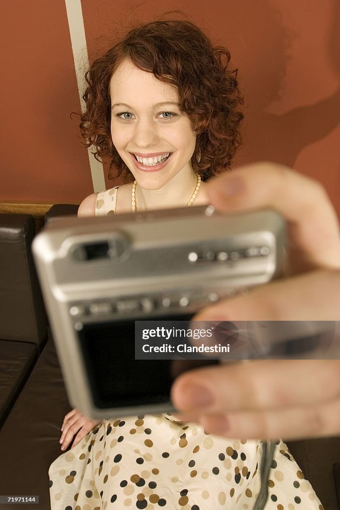 Woman taking photograph of herself