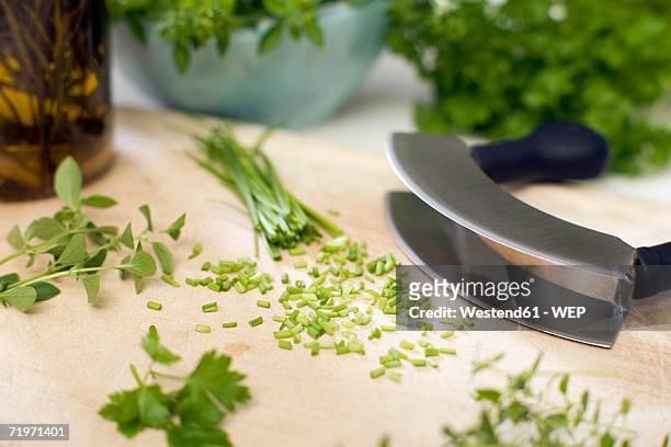 chopped herbs with mezzaluna, close-up - mincing knife stock pictures, royalty-free photos & images