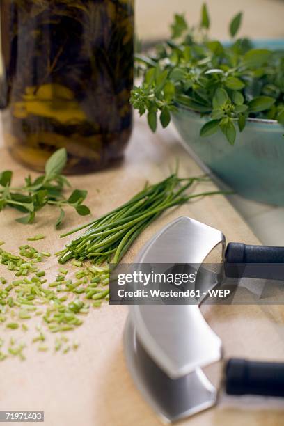 chopped herbs with mezzaluna, close-up - mincing knife stock pictures, royalty-free photos & images