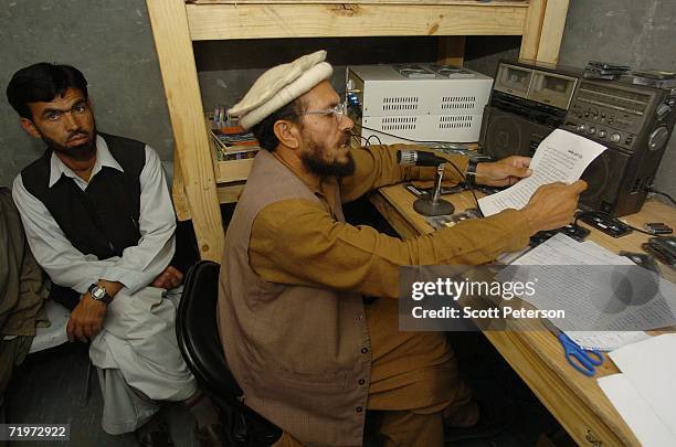 Afghan teacher and Pashto language radio announcer Golamrahim Muridi, with Nuristani language announcer Golham Jilani , broadcasts news and popular...