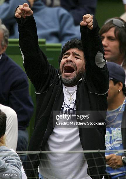 Football legend Diego Maradona cheers as Jose Acasuso of Argentina plays Lleyton Hewitt of Australia during the World Group Semifinal of the Davis...