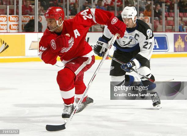 Chris Chelios of the Detroit Red Wings is chased by Tim Taylor of the Tampa Bay Lightning during their NHL pre-season game at Joe Louis Arena...