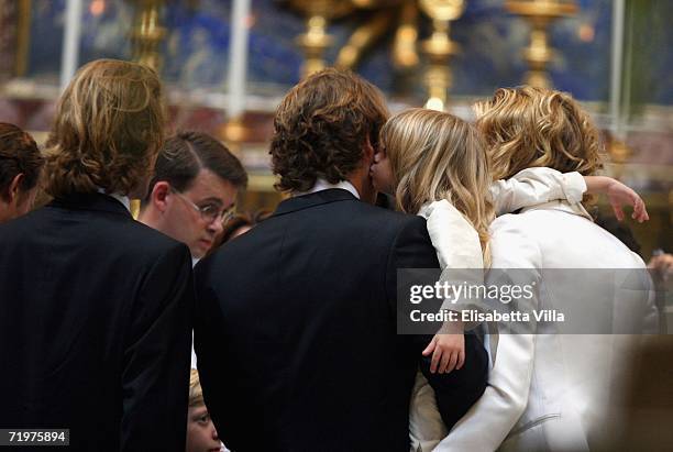 Elle McPherson's son Aurelius kiss his father Arpad Busson as they attend the christening of Aurelius at Basilca Santa Maria Maggiore on September...