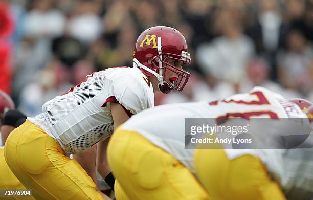 Quarterback Bryan Cupito of the Minnesota Golden Gophers calls out singnals as he stands under center at the line of scrimmage against the Purdue...