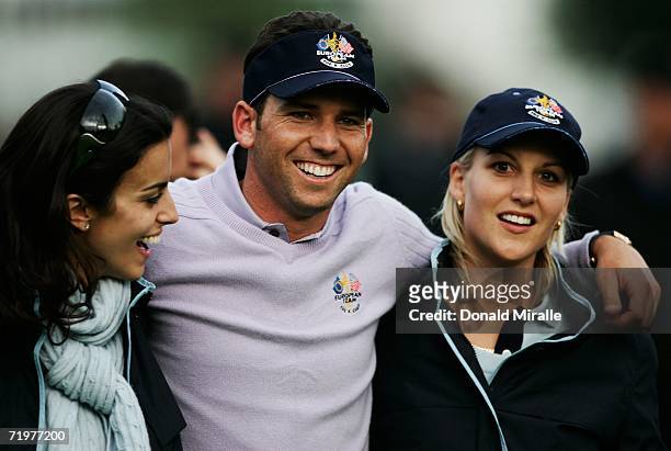 Sergio Garcia of Europe is hugged by Henrik Stenson's girlfriend Emma Lofgren and Luke Donald's fiancee Diane Antonopoulos during the afternoon...