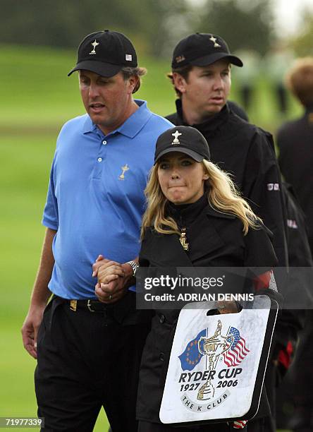 United States Ryder Cup player Phil Mickelson walks with his wife Amy, after losing with team-mate David Toms to the European team of Sergio Garcia...