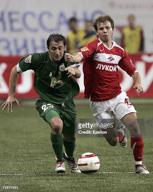 Roman Shishkin of Spartak Moscow competes for the ball with Mikhail Ashvetia of Rubin Kazan during the Football Russian League Championship match...