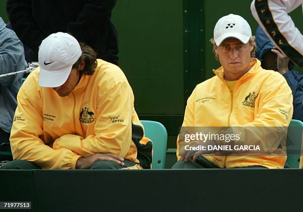 Buenos Aires, ARGENTINA: Australians Mark Philippoussis and Lleyton Hewitt look dejected after Argentine David Nalbandian and Agustin Calleri...