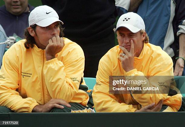 Buenos Aires, ARGENTINA: Australians Mark Philippoussis and Lleyton Hewitt look dejected after Argentine David Nalbandian and Agustin Calleri...