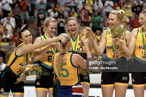 Lauren Jackson of Australia holds up the gold cup for her teammates on the medal stand after the gold medal game between Australia and Russia during...