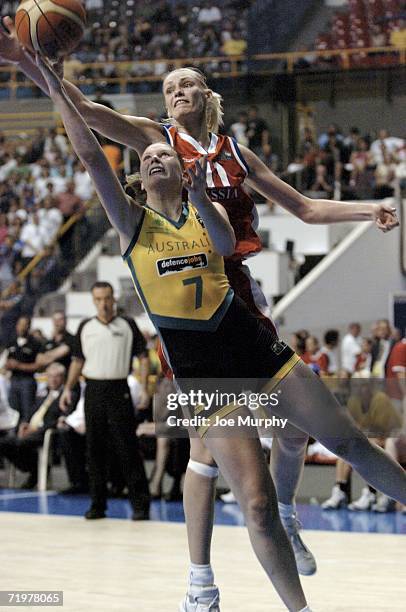 Penelope Taylor of Australia shoots a layup past Maria Stepanova of Russia during the gold medal game during the gold medal game between Australia...