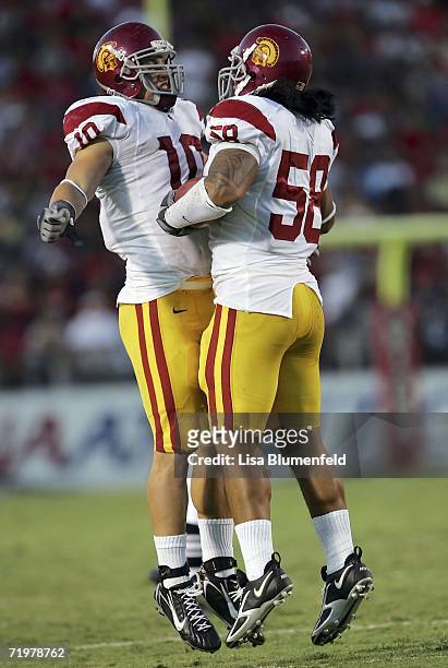 Rey Maualuga of the USC Trojans and Brian Cushing celebrate after Maualuga made a second quarter interception against the Arizona Wildcats during the...