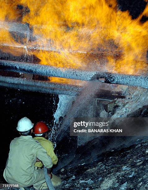 Pakistani fire-fighters extinguish a burning gas pipeline near Quetta, late 23 September 2006. Insurgents blew up a natural gas pipeline in the...