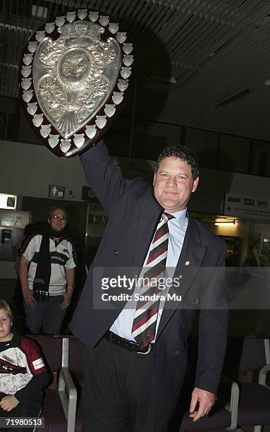 North Harbour Coach Allan Pollock lifts the shield as the North Harbour team arrive home with the Ranfurly Shield on September 24, 2006 in Auckland,...