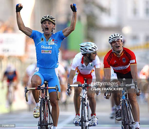 Italian Paolo Bettini celebrates as he crosses the finish line of the men's road cycling crown of the 2006 Cycling World championships followed by...