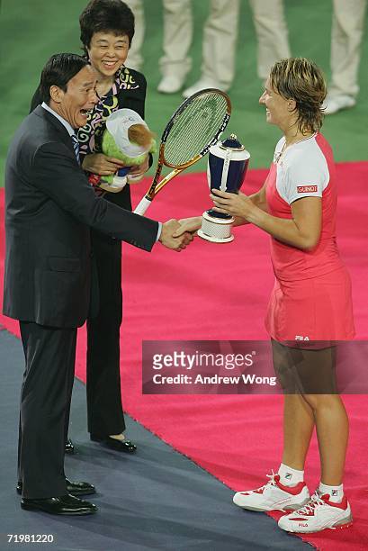 Svetlana Kuznetsova of Russia receives the trophy from Beijing Mayor Wang Qishan during the victory ceremony after she beat Amelie Mauresmos of...