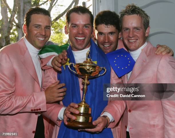 Sergio Garcia, Paul Casey, Padraig Harrington and Luke Donald of Europe pose with The Ryder Cup Trophy after Europe win the Ryder Cup by a score of...