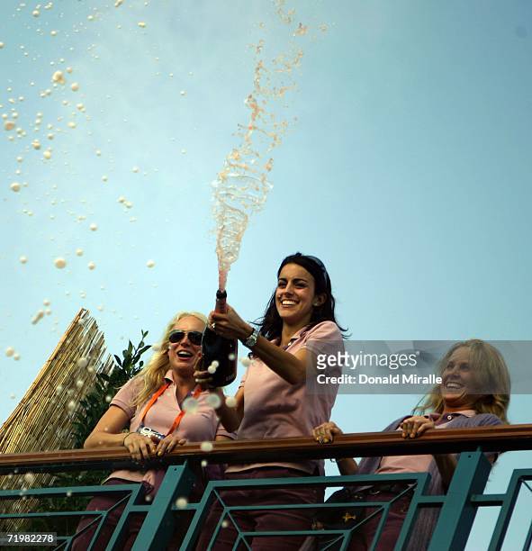 Paul Casey's girlfriend Jocelyn Hefner, Luke Donald's fiancee Diane Antonopoulos and Morgan Norman celebrate on the clubhouse balcony with champagne...