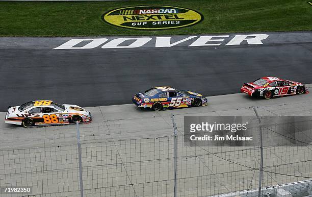 Elliott Sadler, driver of the Dodge Dearlers/UAW Dodge, leads Michael Waltrip, driver of the NAPA Dodge, and Dale Jarrett, driver of the UPS Ford,...