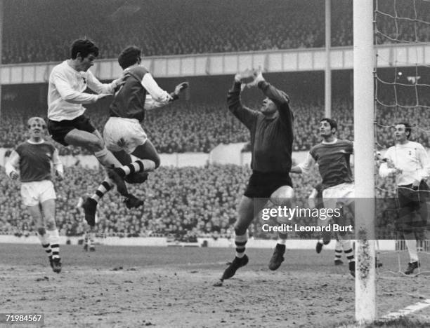 Tottenham Hotspur winger Jimmy Robertson heads the ball goalwards during a match against Arsenal at White Hart Lane, 20th January 1968. The ball was...