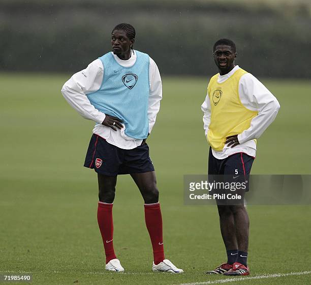 Ade-Akin-Bayor and Kolo Toure of Arsenal look on during an Arsenal training session at their training ground before their UEFA Champions League Group...