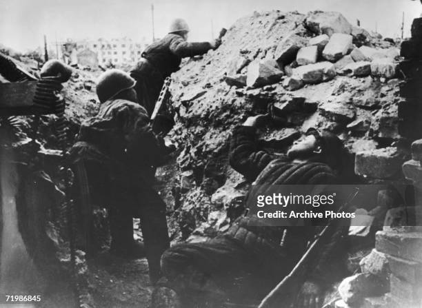 Soldiers in a trench during the Battle of Stalingrad, World War II, circa 1942. In the background is the apartment block known as Pavlov's House, in...
