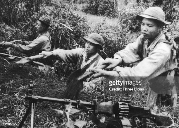 Viet Cong soldiers dig a trench to be used as a heavy machine gun position during the Vietnam war, circa 1968.