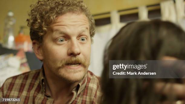 selective focus blurred view of abusive boyfriend holding girlfriends head ready to strike in kitchen - abusive husband stock pictures, royalty-free photos & images