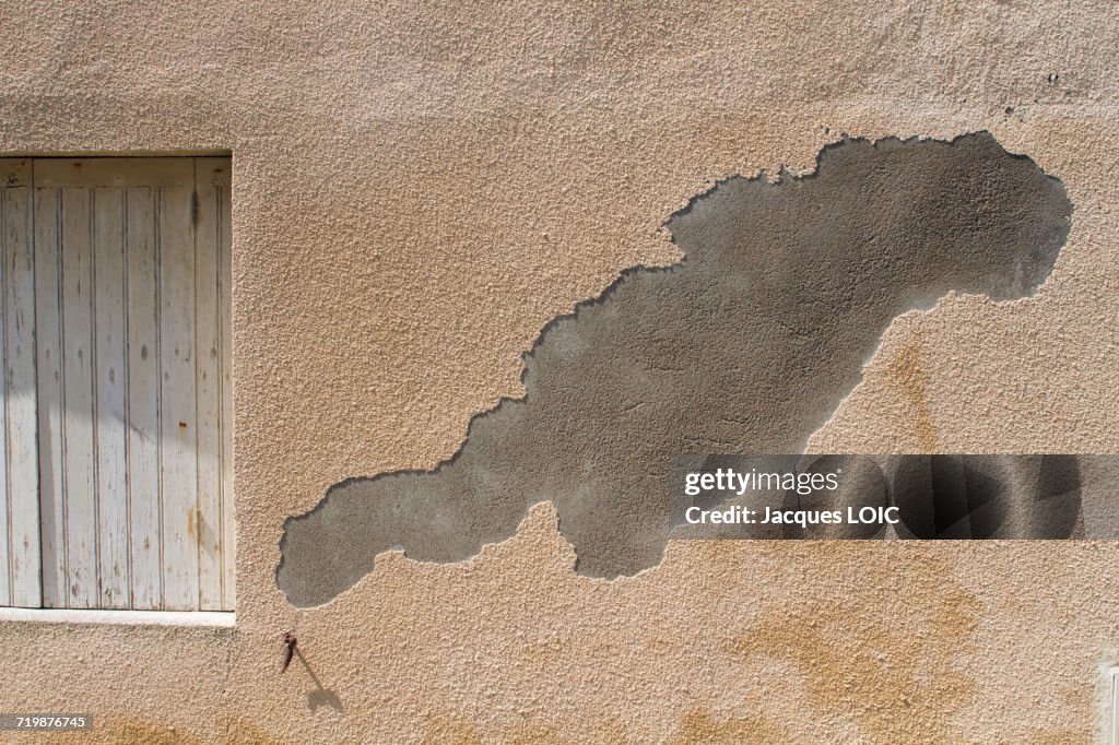 France, ripped out rendering on the wall of a private mansion