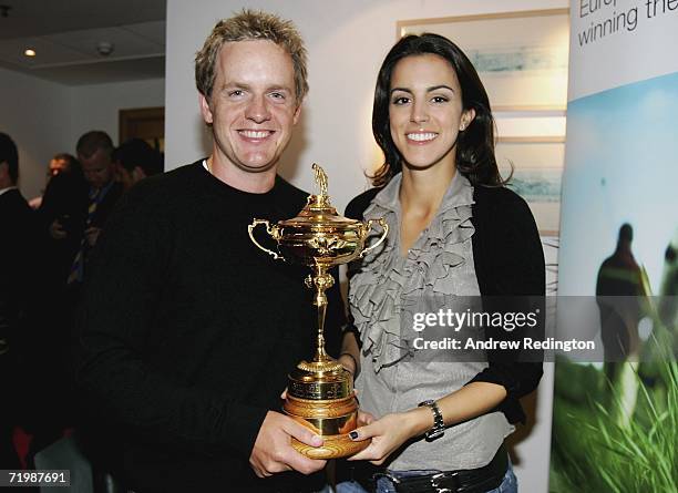 Luke Donald of England and his fiancee Diane Antonopoulos pose with the Ryder Cup trophy as some of the victorious European Ryder Cup team gather at...