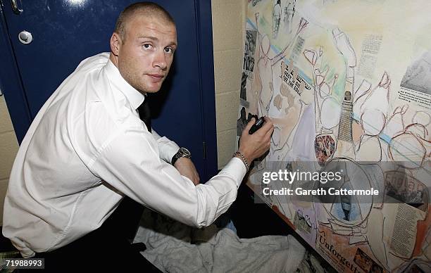 Andrew Flintoff signs a canvas by artist Sacha Jafri at the Professional Cricketers Association Awards Dinner held at The Royal Albert Hall on...