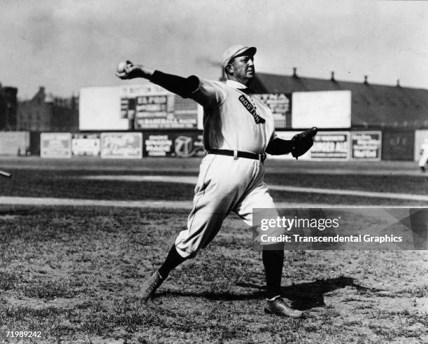 Cy Young, pitcher for the Boston Red Sox, warms up before a game at Huntingdon Ave. Grounds in Boston in 1908.