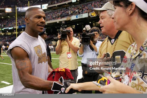 Wide receiver Joe Horn of the New Orleans Saints greets fans during warm ups prior to the Monday Night Football game against the Atlanta Falcons on...