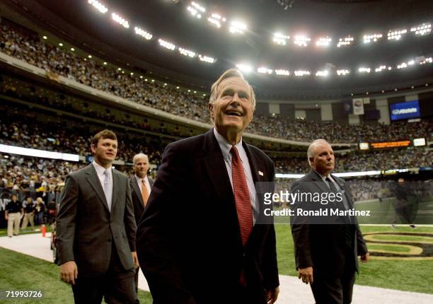 Former President of the United States, George H. W. Bush walks on the field for the coin toss prior to the Monday Night Football game between the...