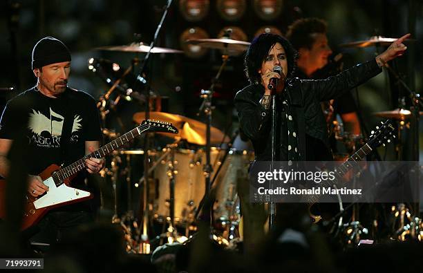 Billie Joe Armstrong of Green Day performs with The Edge of U2 prior to the Monday Night Football game between the Atlanta Falcons and the New...