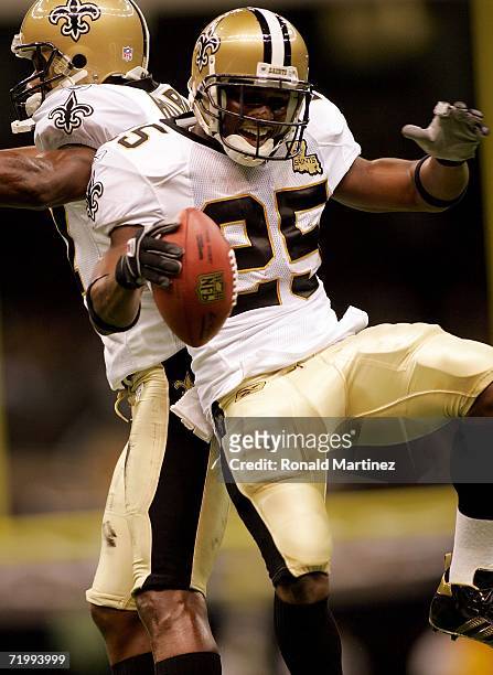 Runningback Reggie Bush of the New Orleans Saints jumps in the air with teammate wide receiver Joe Horn prior to the start of the Monday Night...