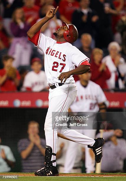 Vladimir Guerrero of the Los Angeles Angels of Anaheim points to the sky after hitting a solo home run in the eighth inning against the Texas Rangers...