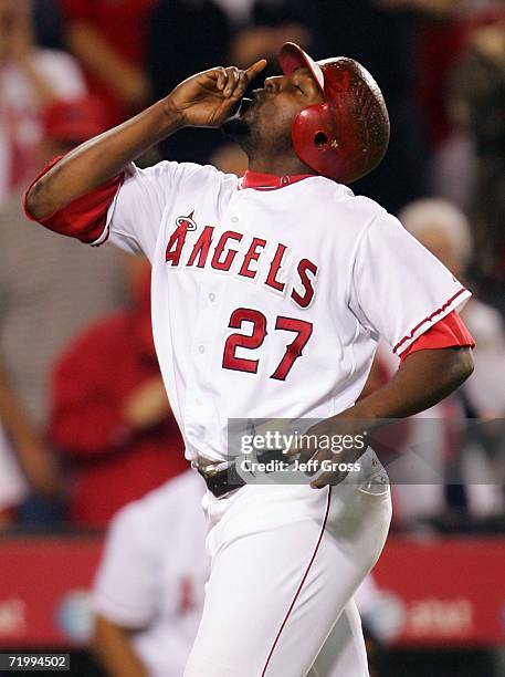 Vladimir Guerrero of the Los Angeles Angels of Anaheim points to the sky after hitting a solo home run in the eighth inning against the Texas Rangers...