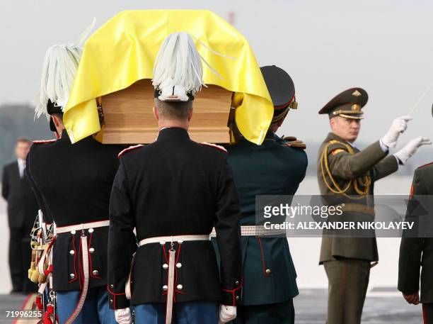 Danish guards of honour carry a coffin of Russian Empress Maria Fiodorovna covered by the old Russian standard upon their arrival in St.Petersburg,...
