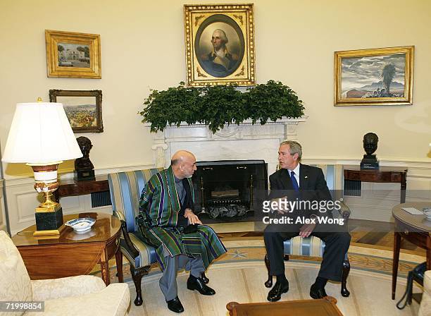 President George W. Bush talks with Afghan President Hamid Kaizai during their meeting in the Oval Office of the White House September 26, 2006 in...