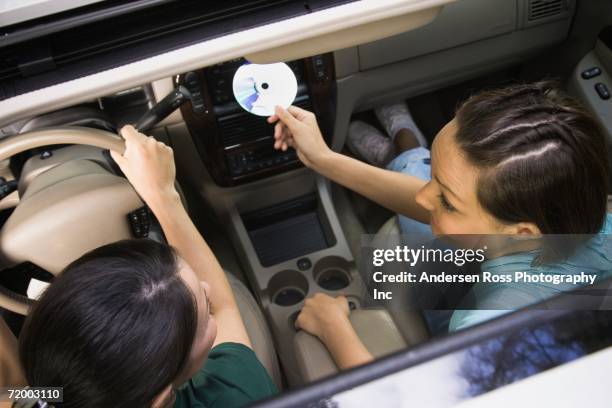 view through sunroof of two women in car - compact disc fotografías e imágenes de stock