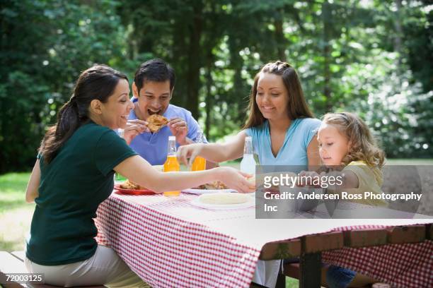 hispanic family eating at picnic table - hot latino girl imagens e fotografias de stock