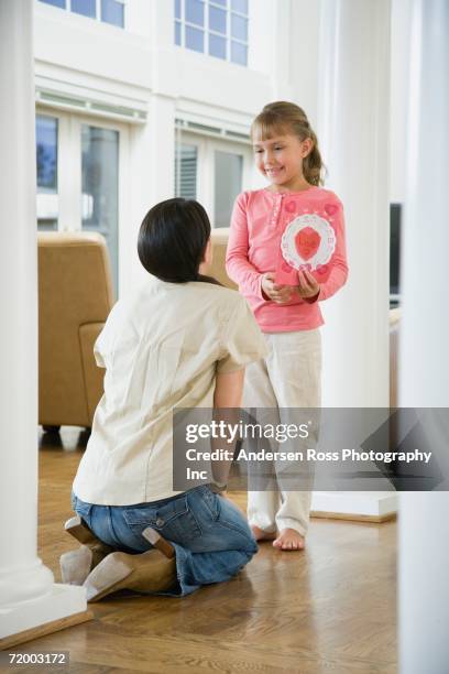 daughter giving valentine's day card to mother - bare feet kneeling girl stock pictures, royalty-free photos & images