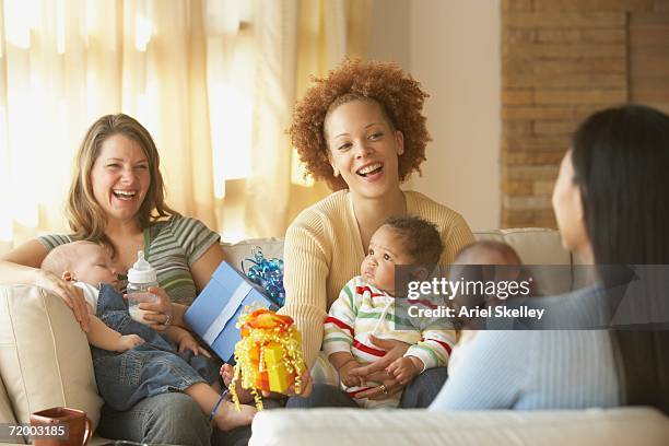 young mothers with babies and gifts - babyshower stock pictures, royalty-free photos & images