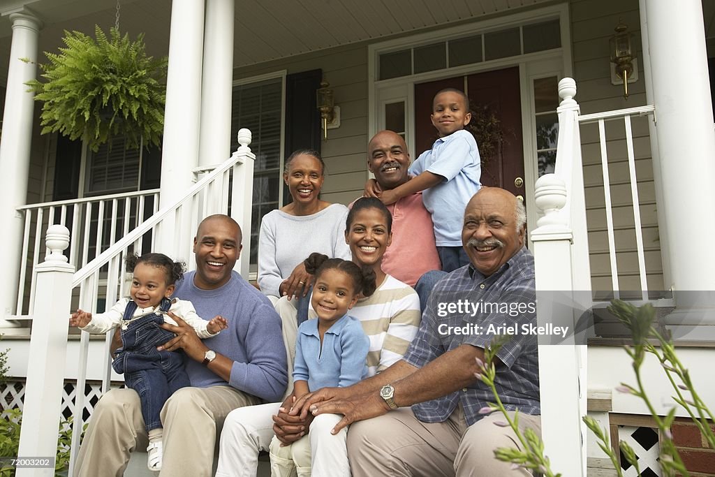 Multi-generational African family smiling on porch