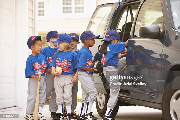 children in baseball outfits getting into car - ungdomsliga för baseboll och softboll bildbanksfoton och bilder