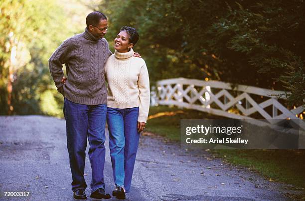 senior african couple walking outdoors - mature couple winter outdoors stockfoto's en -beelden