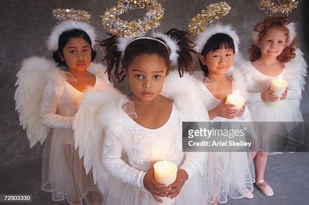 group of girls in angel costumes holding candles - kerstkind stockfoto's en -beelden