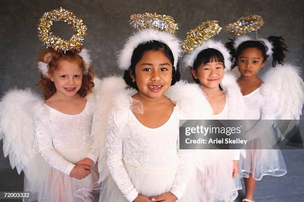 group of girls in angel costumes smiling - kerstkind stockfoto's en -beelden