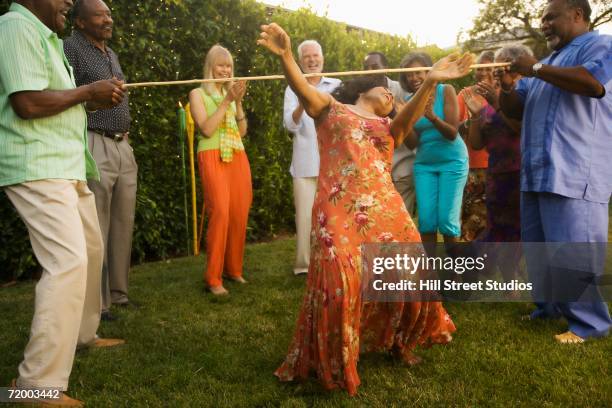 african woman doing the limbo outdoors - limbo stock-fotos und bilder